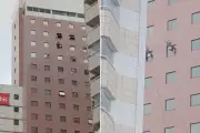 Trabalhadores pendurados em fachada de hotel durante ventania em Santos